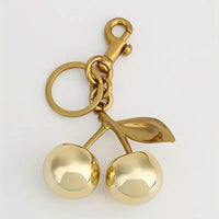 Golden Cherry Keychain Charm – Shiny Resin & Metal Bag Accessory, Elegant Gift for Women, Purse or Handbag Decoration